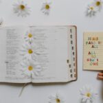 An Open Bible with Flowers and a Notepad